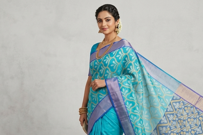 Woman wearing a turquoise and blue saree with a white background