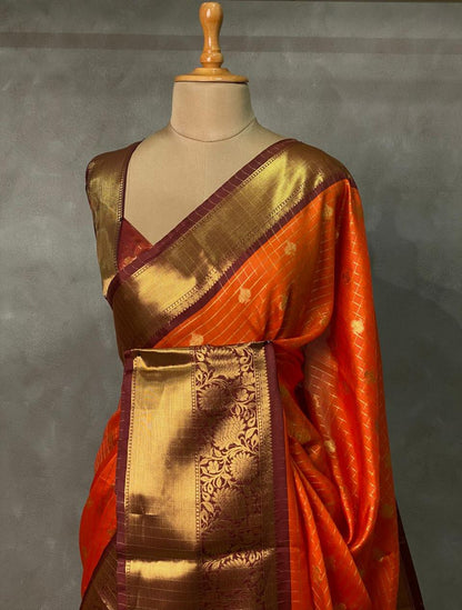 Elegant orange Banarasi silk saree with intricate zari buttas and rich pallu 