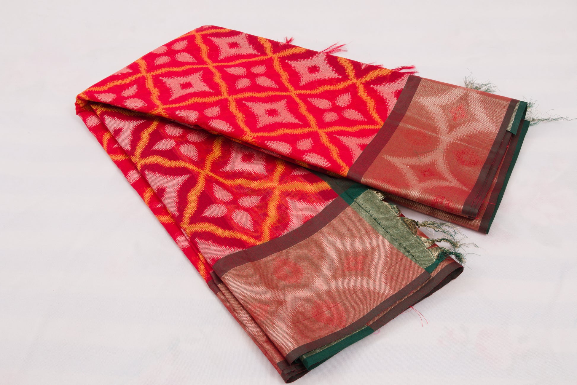 Elegant Pochampally Ikat silk saree with intricate woven designs and tassel detailing 