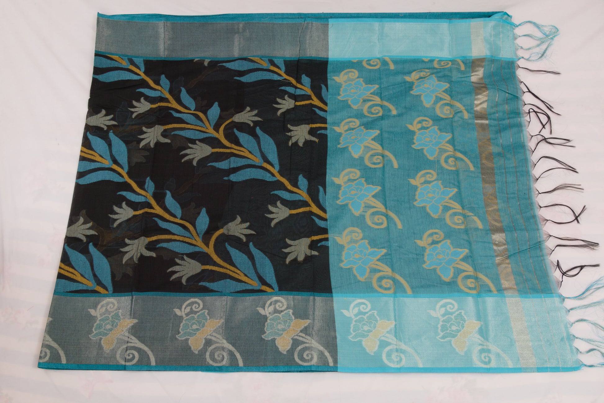 Saree with black and blue floral patterns on a white background