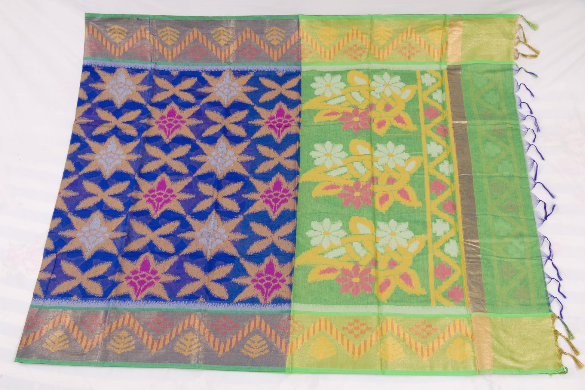 Traditional Indian handloom saree with blue geometric body and green floral border 