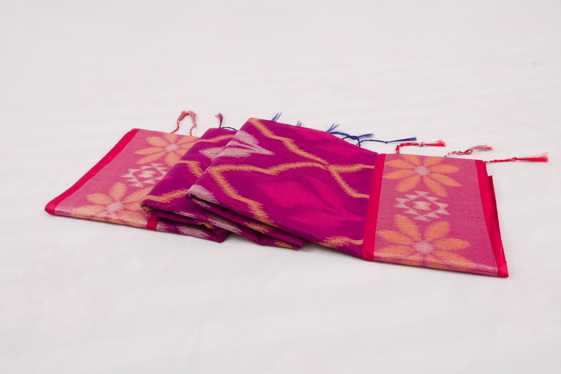 Traditional Indian handloom saree with blue geometric body and green floral border 