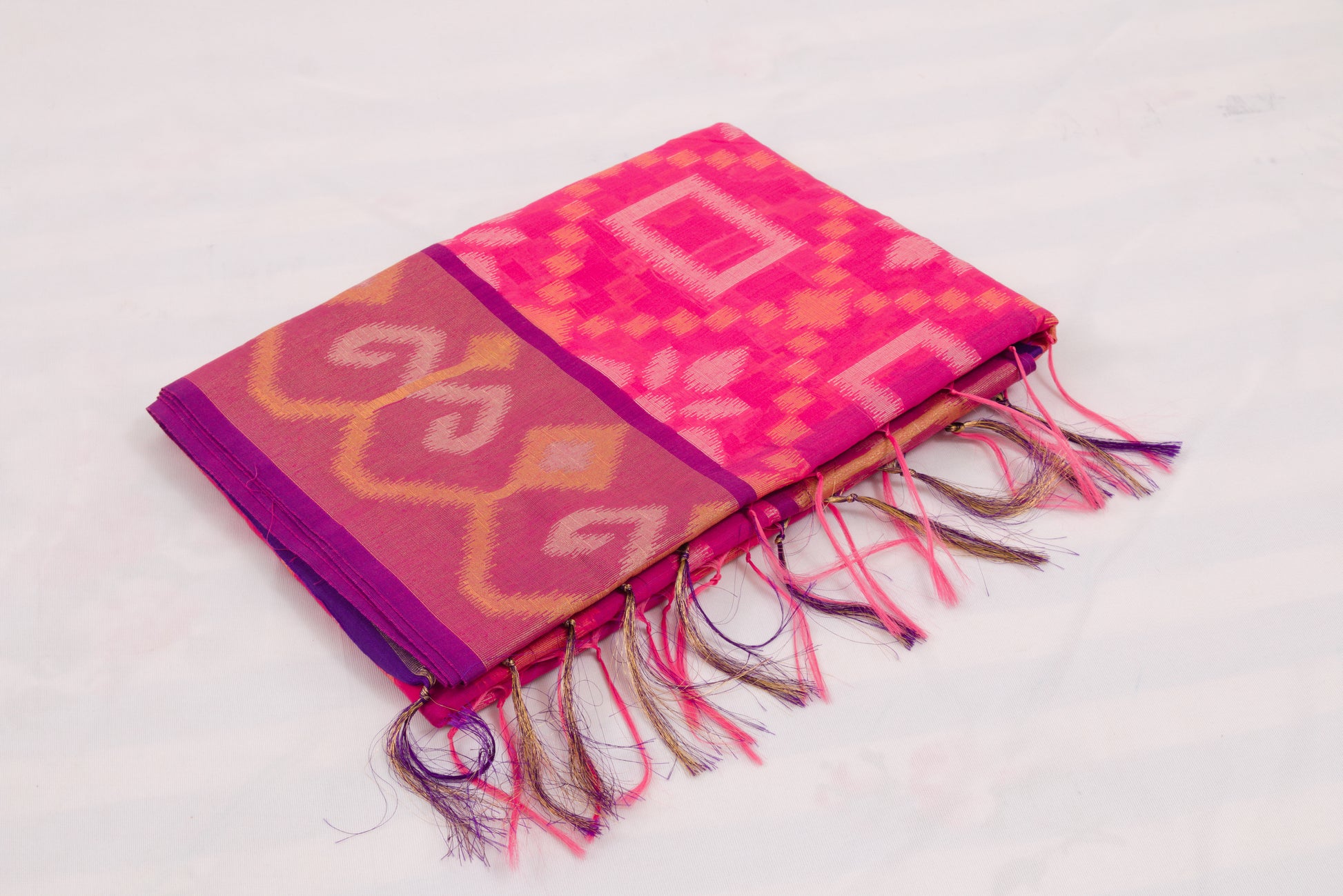Elegant Pochampally Ikat silk saree with intricate woven designs and tassel detailing 