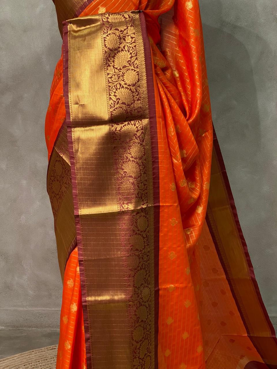 Close-up of Banarasi semi Katan saree showcasing gold zari weaving and texture 