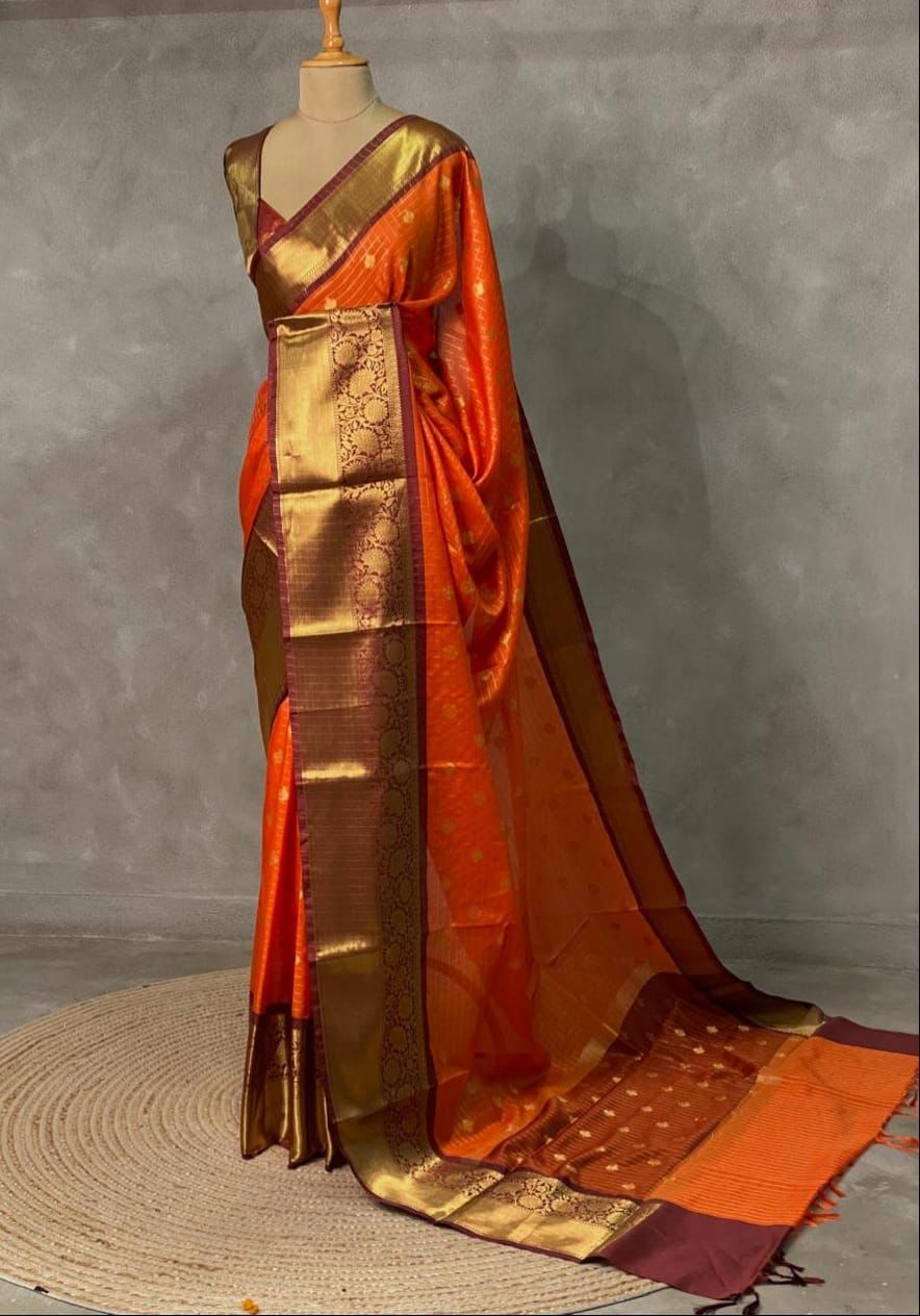 Orange silk saree with traditional Banarasi motifs and lustrous zari work 