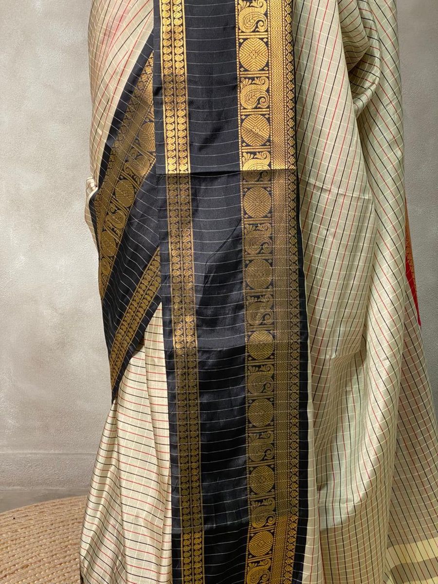 Banarasi saree draped on mannequin with maroon border and detailed pallu 