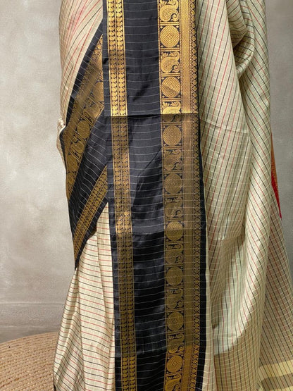 Banarasi saree draped on mannequin with maroon border and detailed pallu 