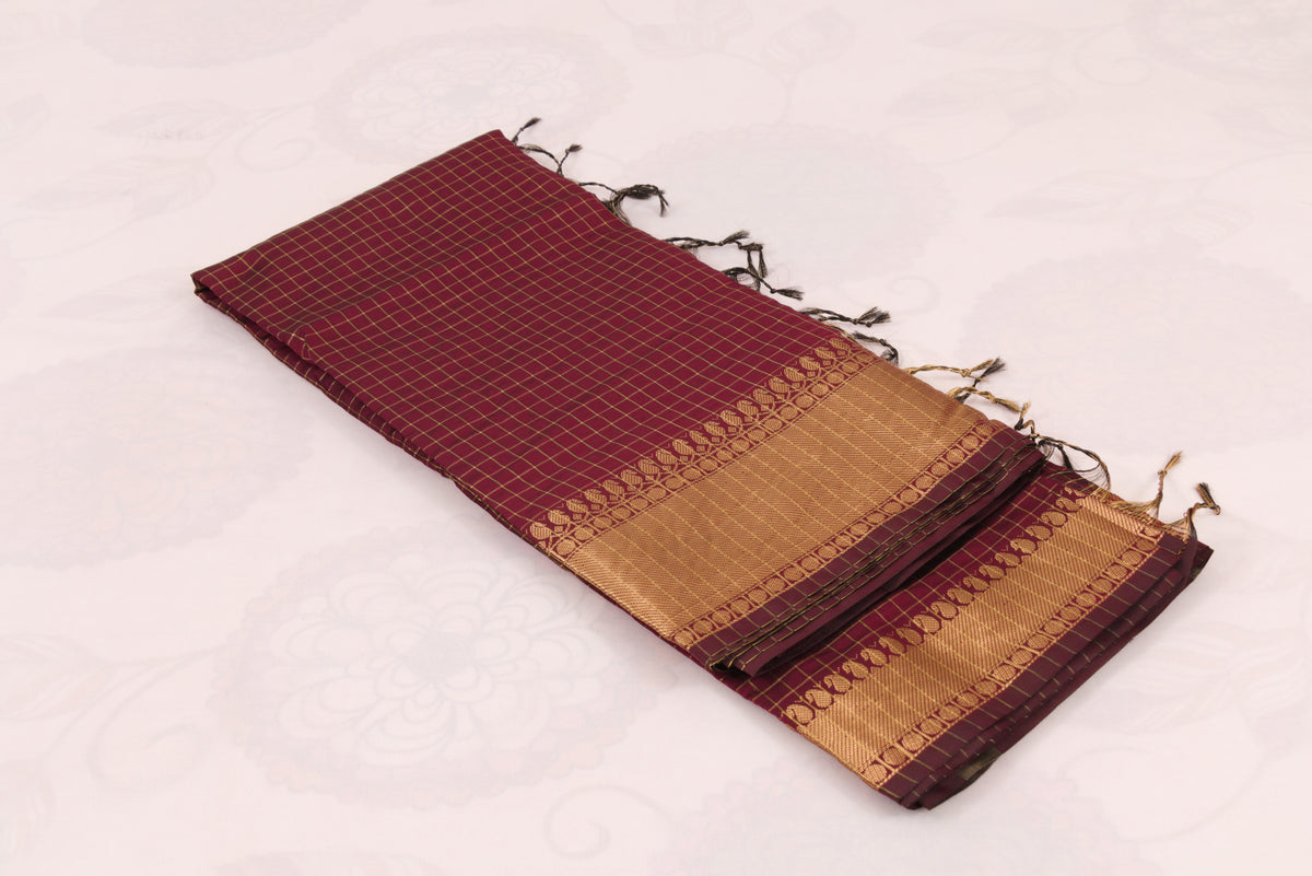 Banarasi Semi Katan Saree in Wine Berry with gold zari woven buti motifs, elegant check pallu, and matching blouse material